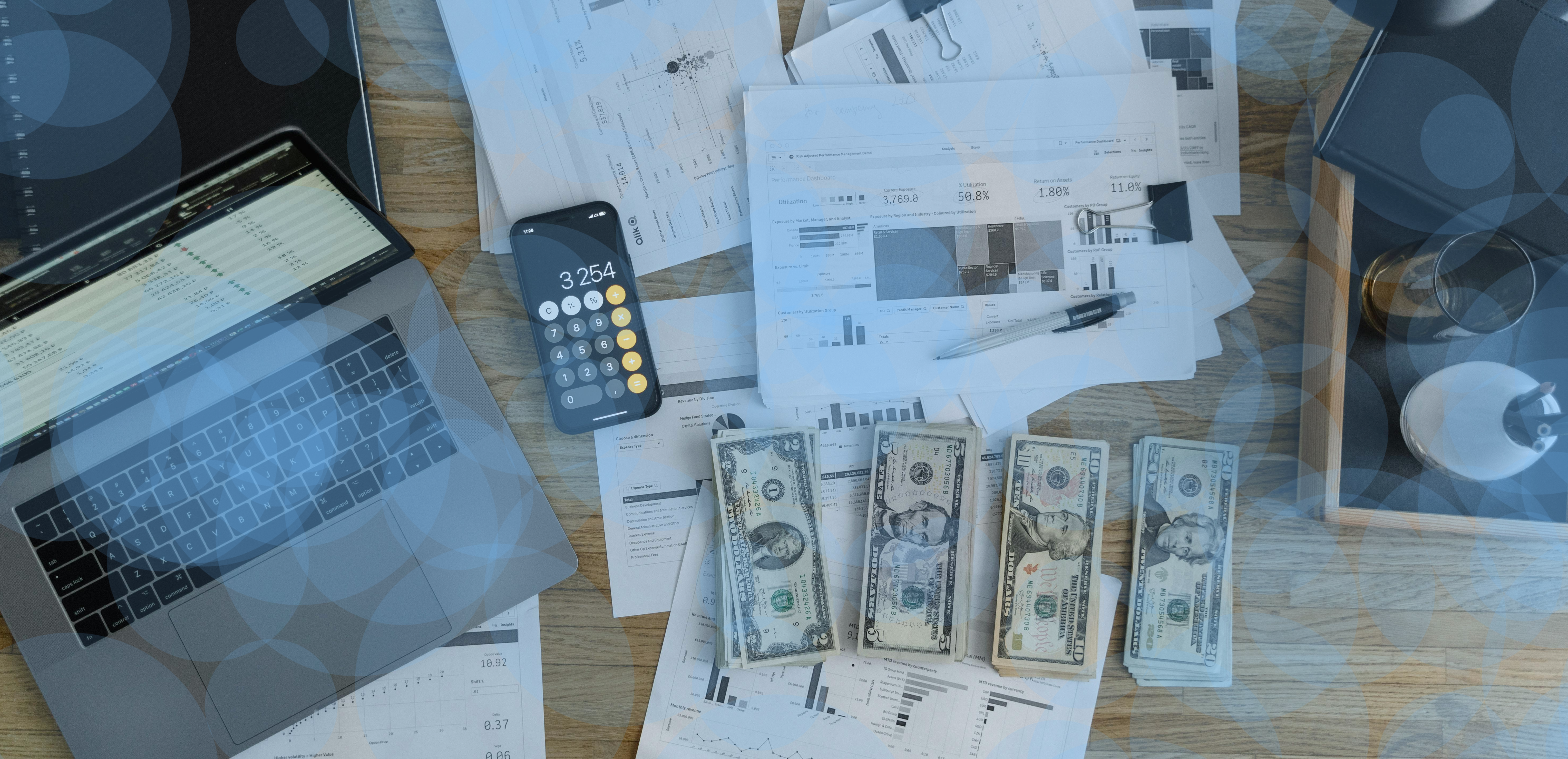 Desk with computer, money, calculator, and documents to signify the profits you can achieve by partnering with Snowman Holdings Group